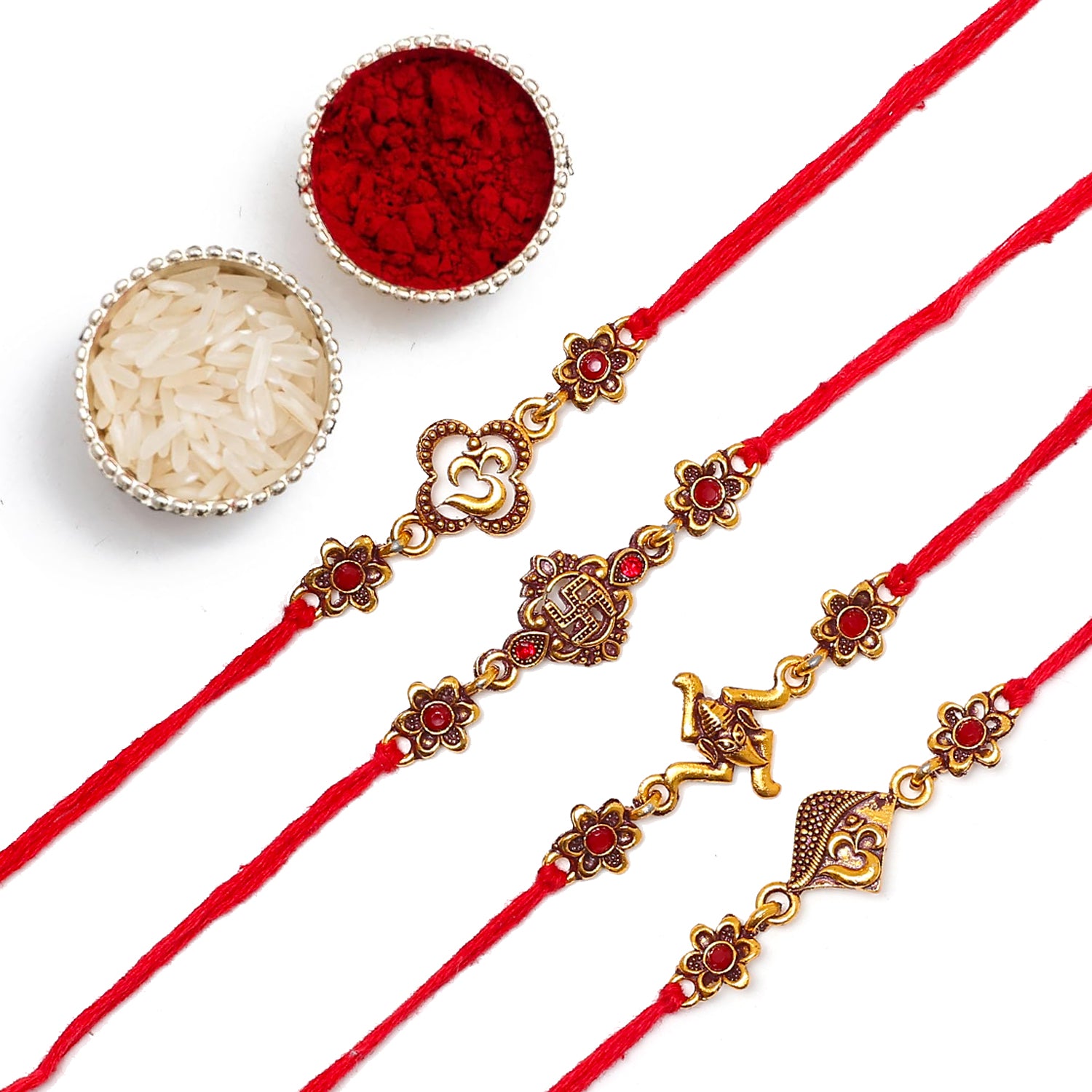 Three red rakhi with intricate gold and silver designs.