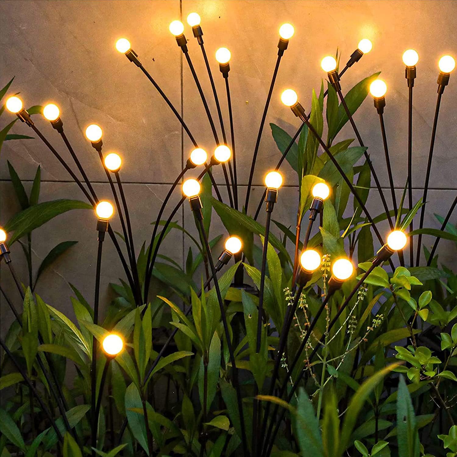 A serene garden adorned with a cluster of vibrant lights illuminating the surroundings.