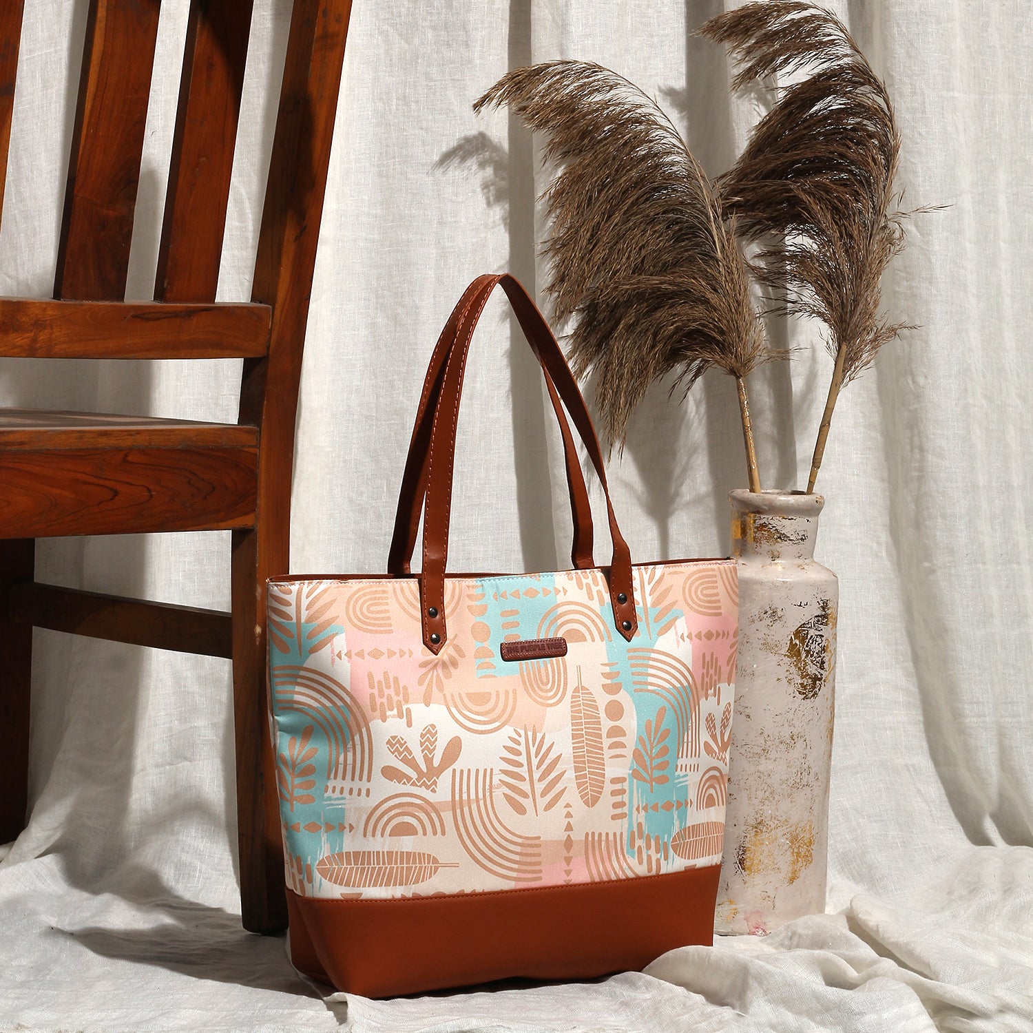 Light blue and pink patterned tote bag, perfect for carrying essentials in style.