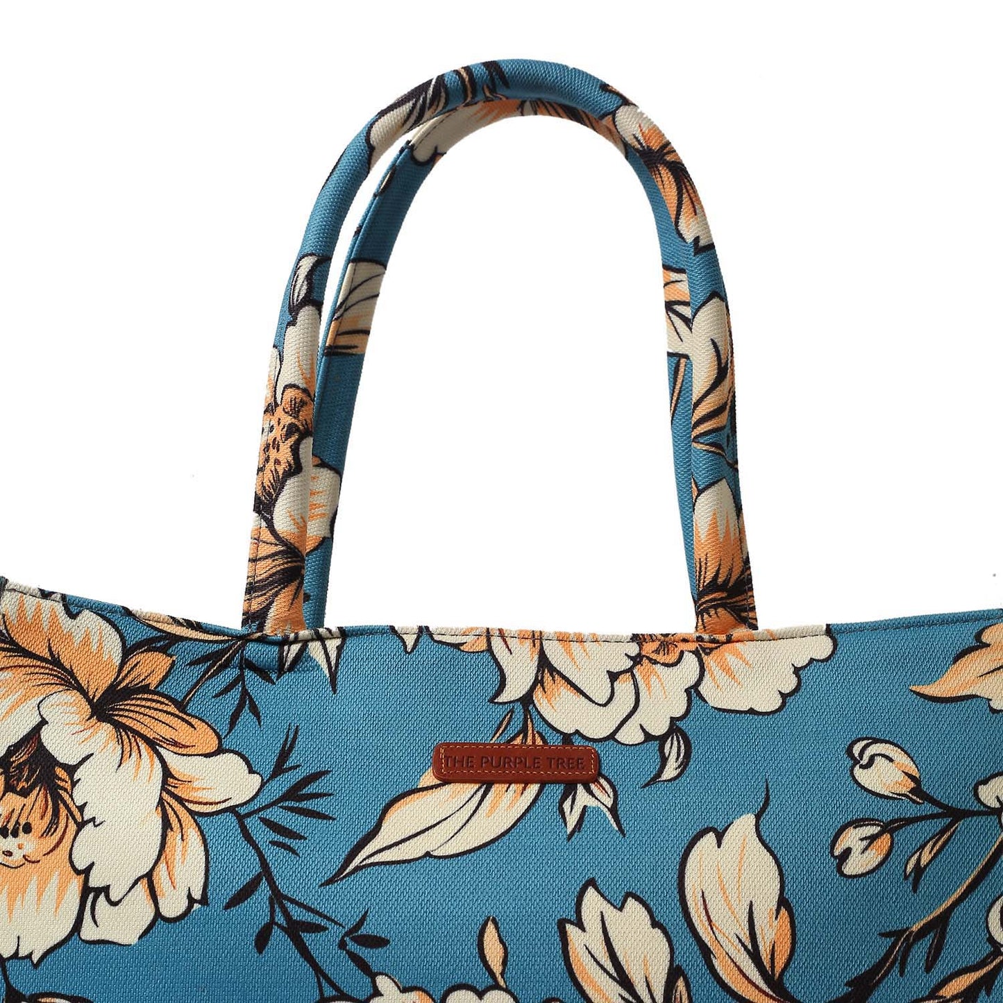 Chic tote bag with floral pattern, book, and notebook.