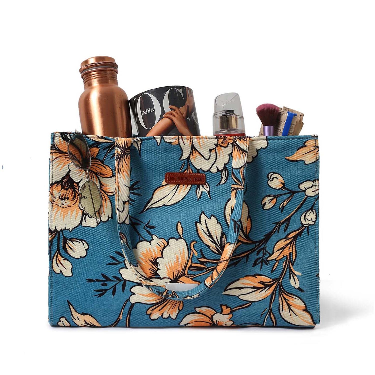 A floral print tote bag with a blue handle, perfect for adding a touch of elegance to your outfit.