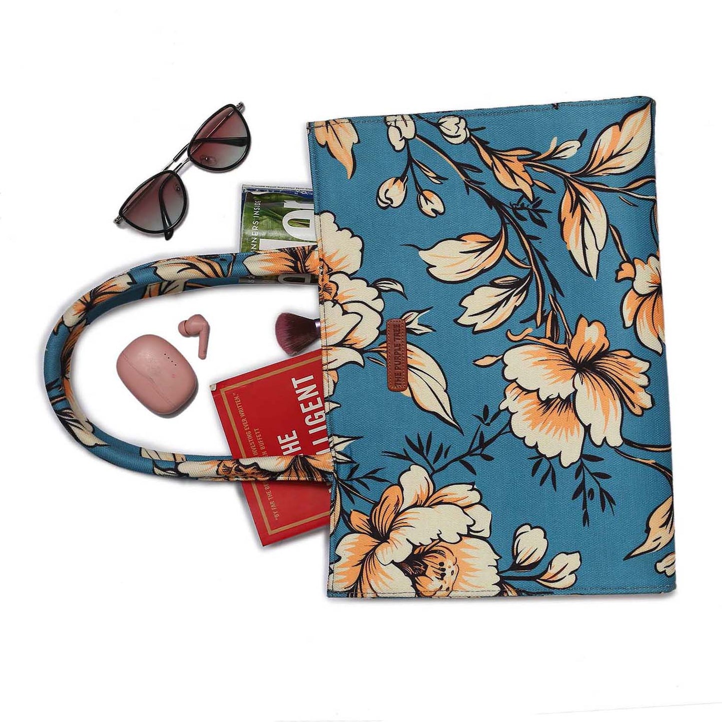 A floral print tote bag with a blue handle, perfect for adding a touch of elegance to your outfit.