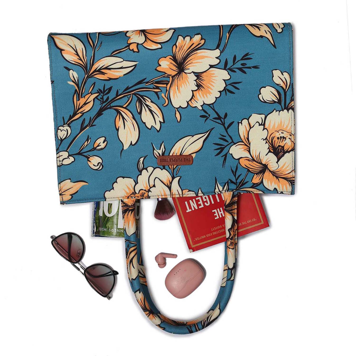 A floral print tote bag with a blue handle, perfect for adding a touch of elegance to your outfit.