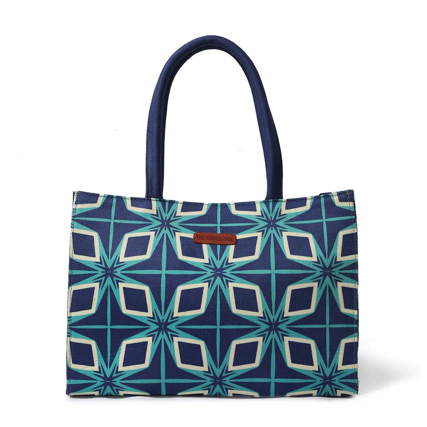Stylish blue and green tote bag with book and sunglasses.