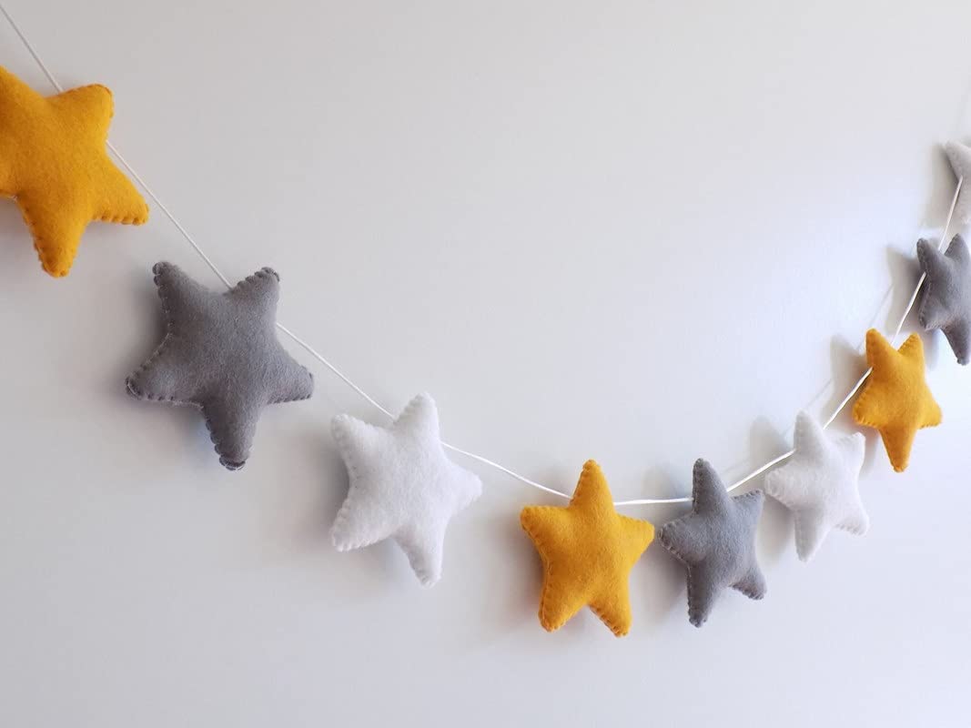 Yellow and gray felt stars garland, perfect for adding a touch of whimsy to your home decor.
