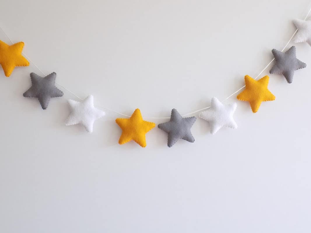 Decorative garland made of yellow and gray felt stars, ideal for adding a festive vibe to any space.