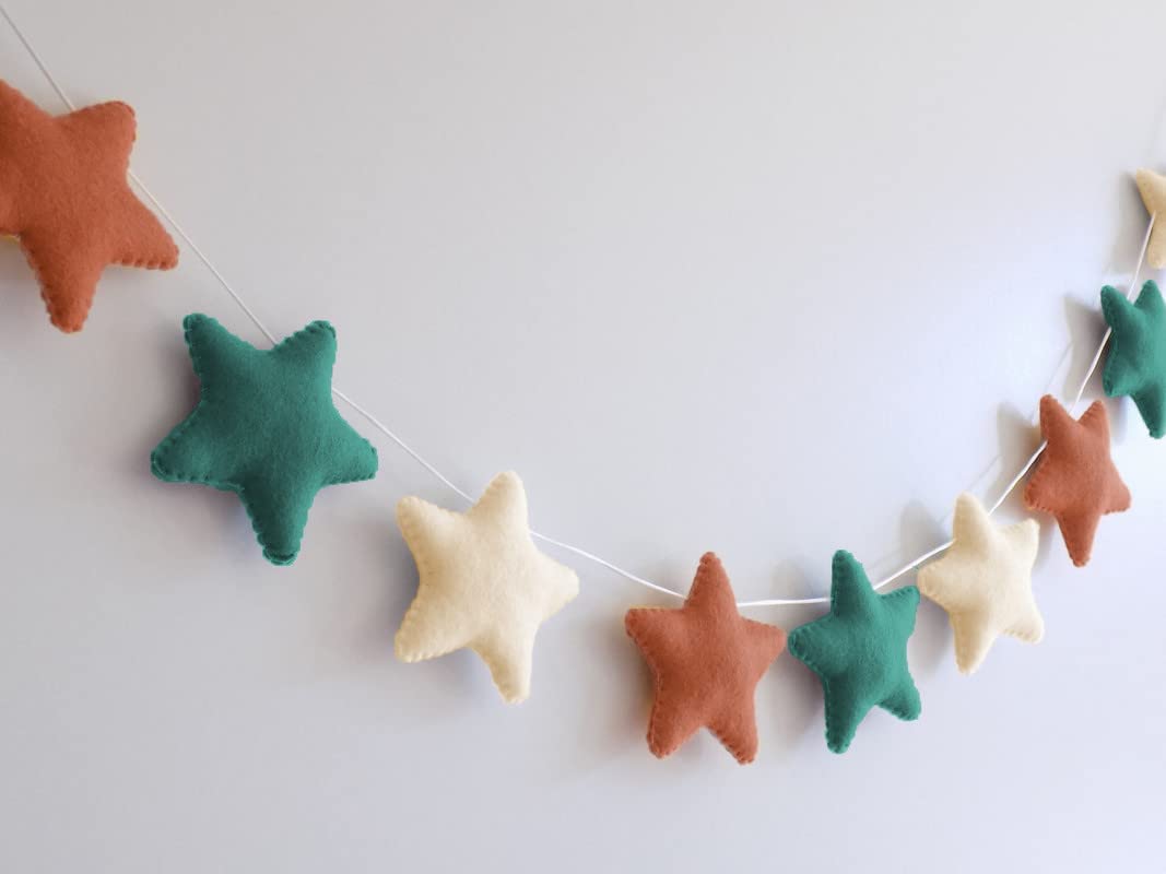 A garland of felt stars hanging on a wall, adding a touch of whimsy and charm to the room decor.