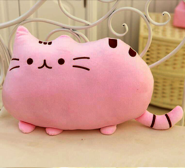 A pink cat-shaped pillow resting on a chair, adding a touch of whimsy and comfort to any space.