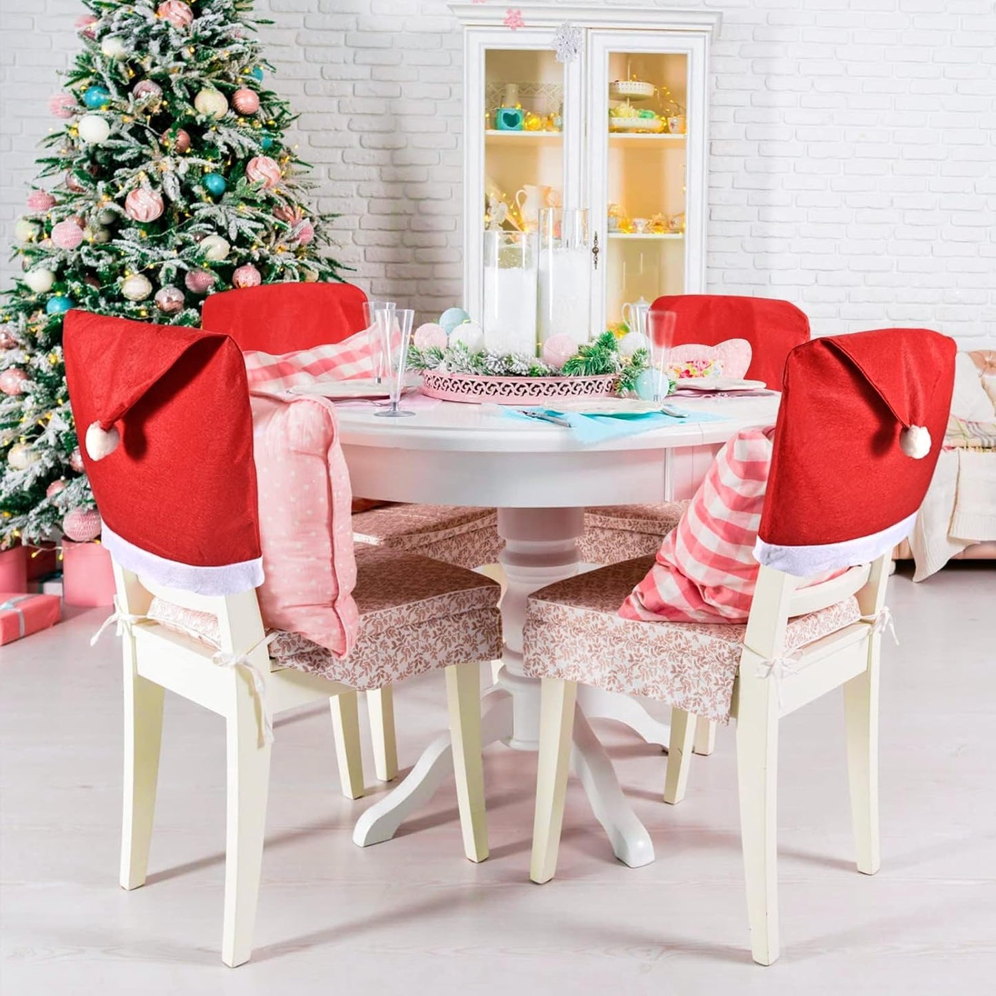 Festive dining area featuring a table, chairs, and a Christmas tree.