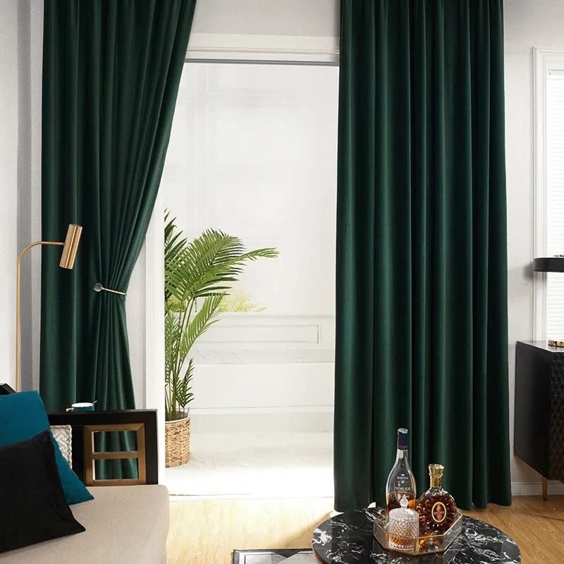 A dark green curtain hanging next to a white vase.