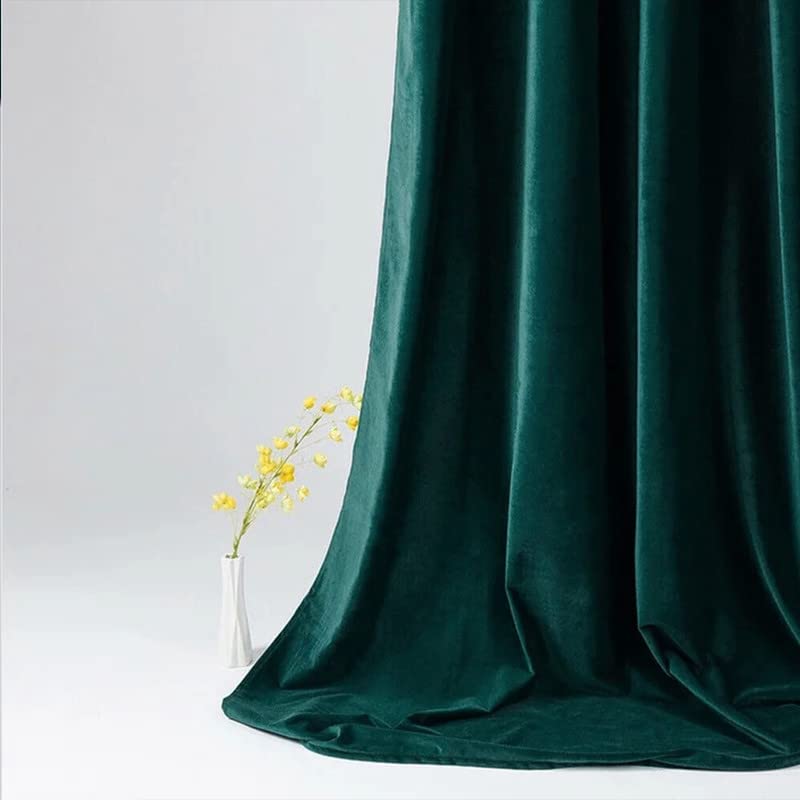  Dark green curtain and white vase in a room setting.
