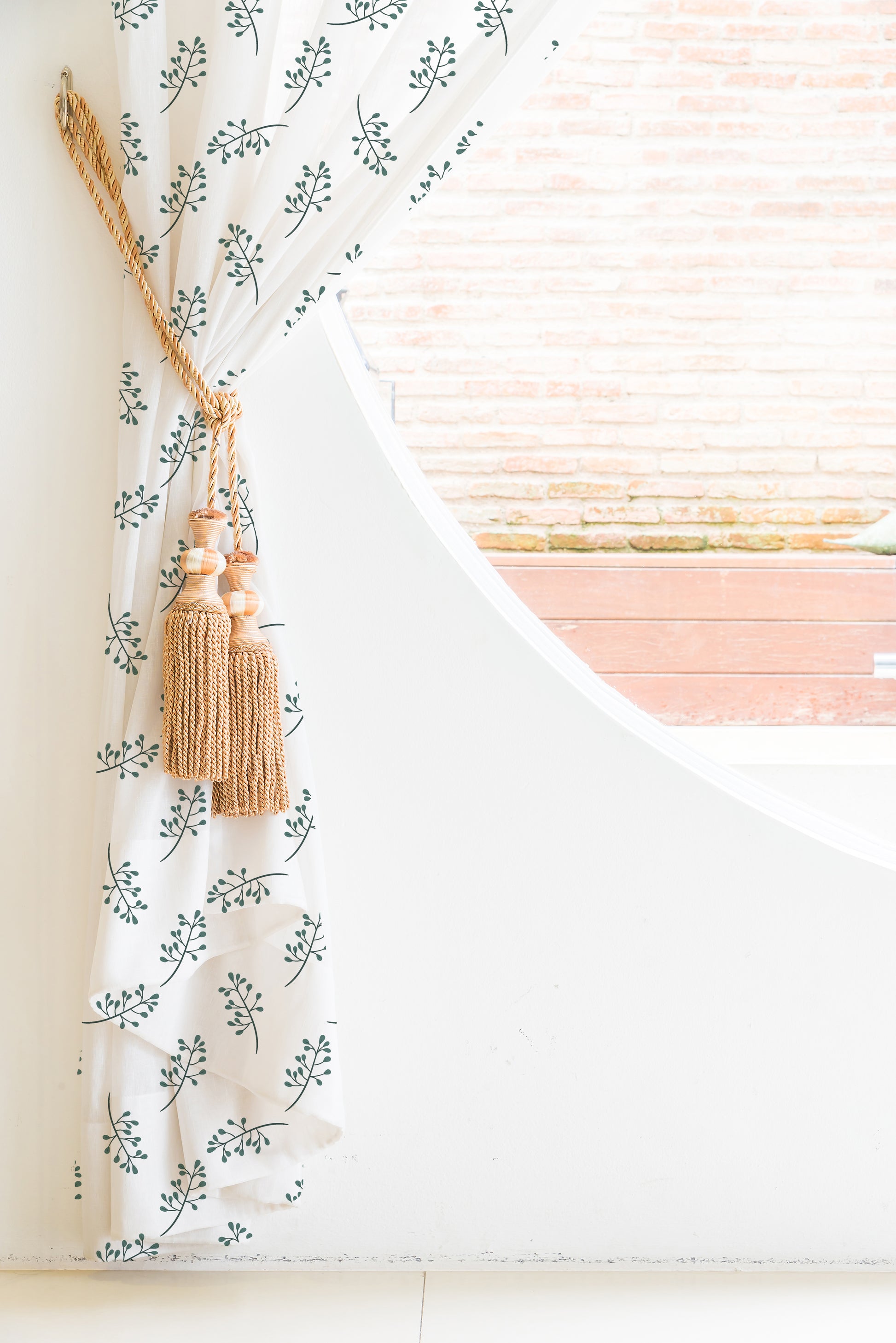 A curtain with a green leaf pattern, adding a touch of nature to the room's decor.