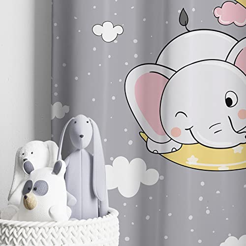 An adorable baby elephant on a moon curtain, with fluffy clouds all around. So cute! 🐘🌙☁️