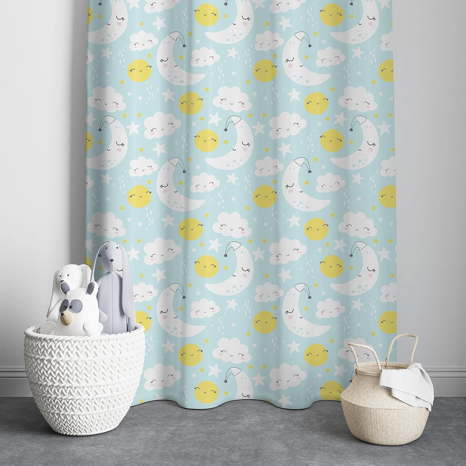 A cheerful blue and yellow curtain adorned with a cute cartoon sun, moon, and fluffy clouds.