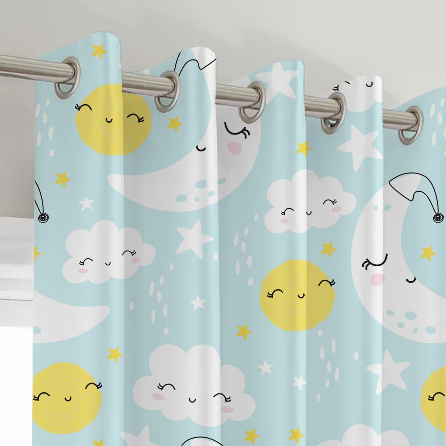 Whimsical design of sun, moon, and clouds on blue and yellow curtain.