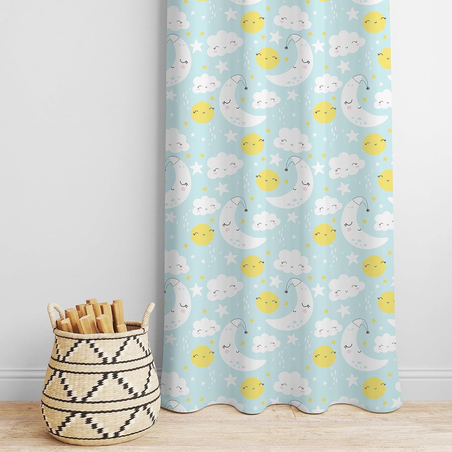 Cartoon sun, moon, and clouds on blue and yellow curtain.