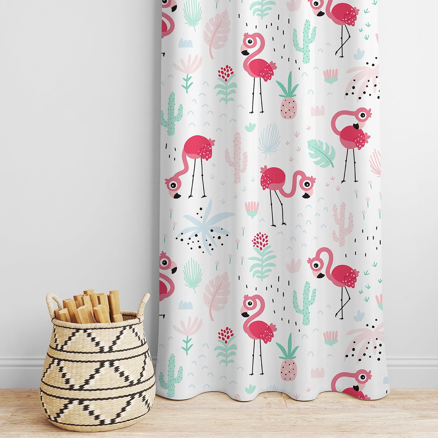 Curtain featuring a pink flamingo and cactus print, complemented by a rustic basket.