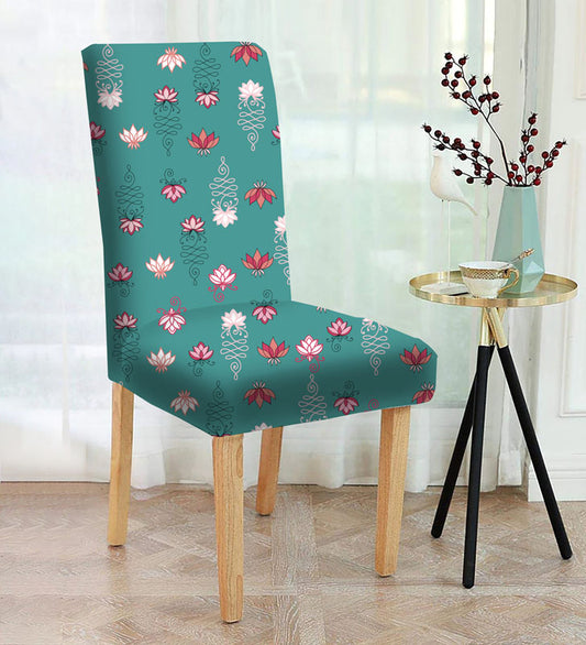  A floral-patterned chair with a vase beside it.