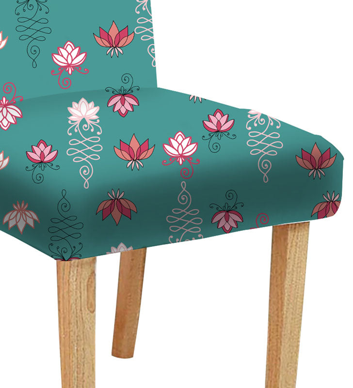 Floral chair with vase on the side.