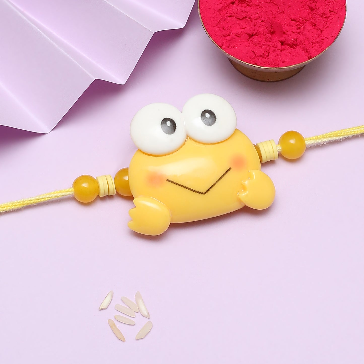 Vibrant yellow frog on pink background.