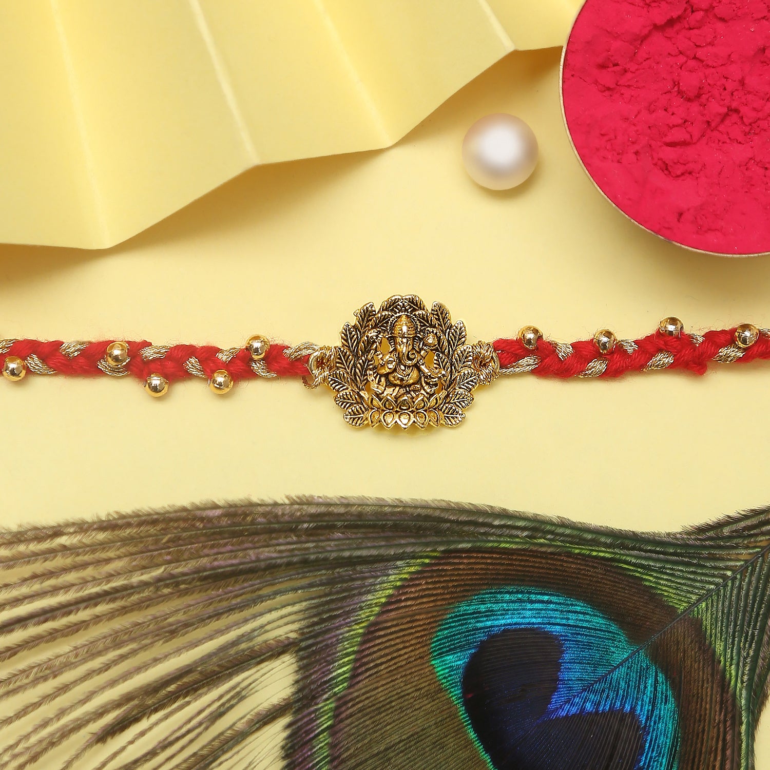  Red Rakhiwith gold coin charm, perfect accessory for a touch of elegance.