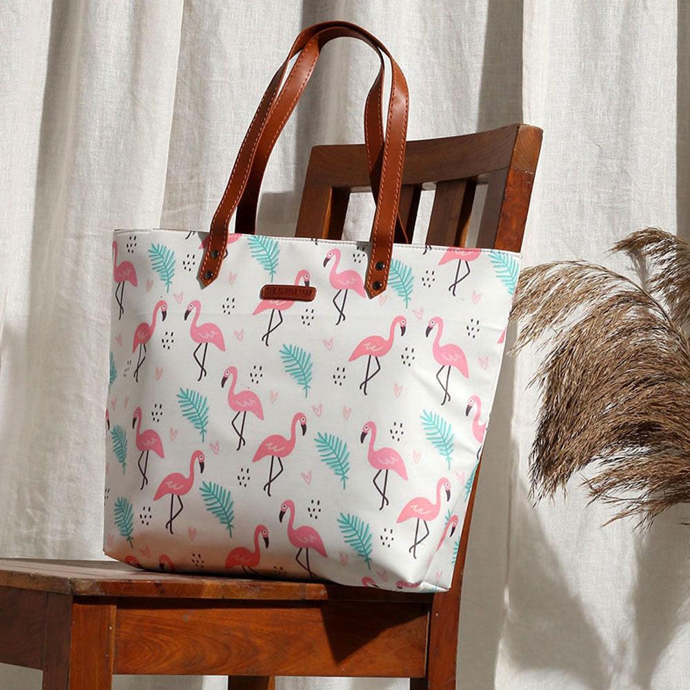 A stylish tote bag with a pink and green flamingo print. Perfect for adding a pop of color to your outfit!