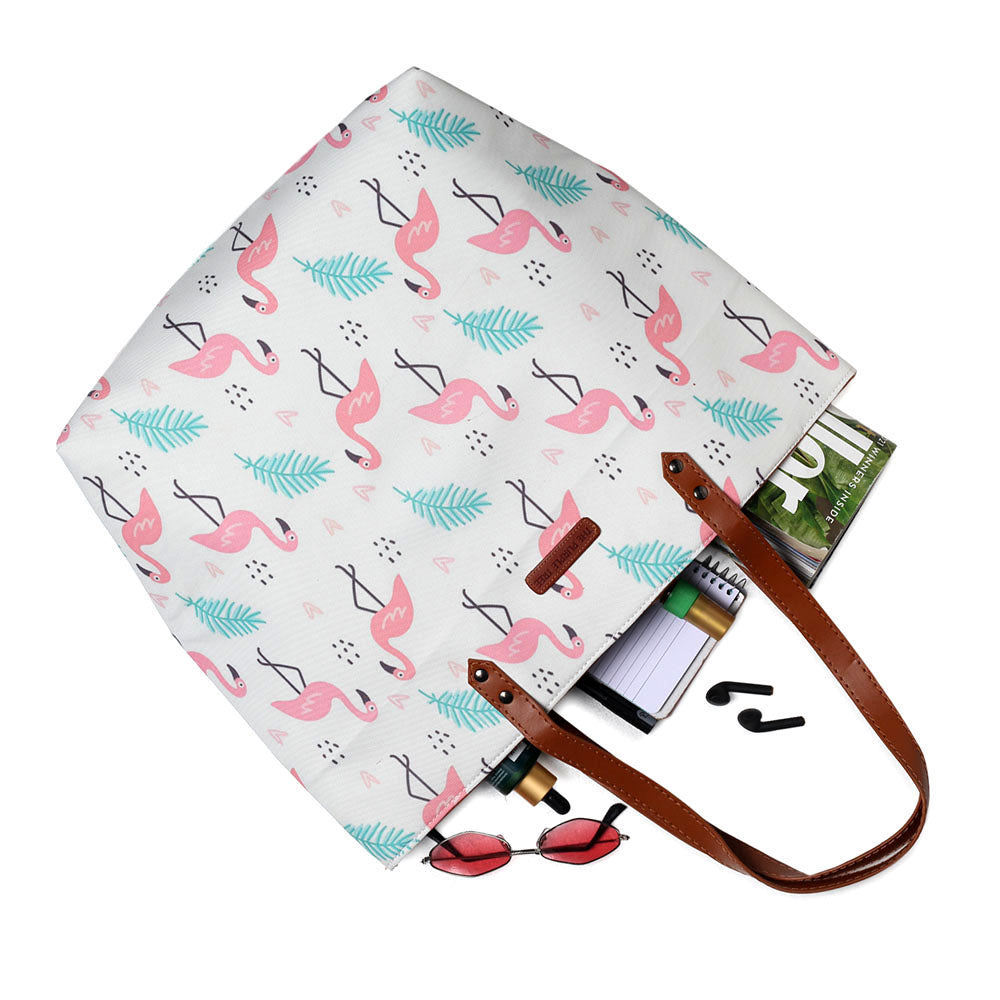 Eye-catching pink and green flamingo print tote bag, a trendy accessory for any occasion.