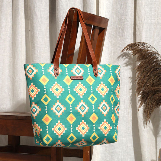 A stylish tote bag with a vibrant tribal pattern in green and yellow colors. Perfect for adding a pop of color to your outfit!