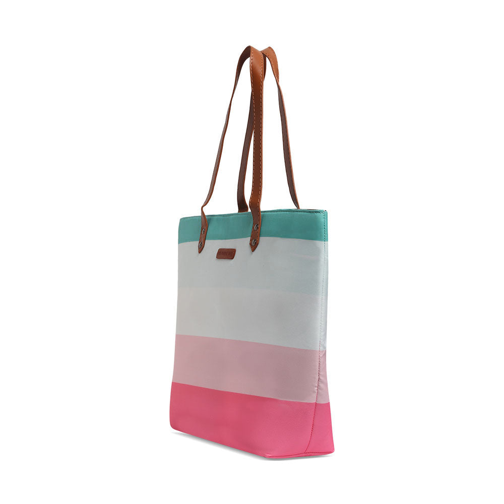  A stylish tote bag with pink, blue, and white stripes, perfect for carrying essentials on a sunny day out.