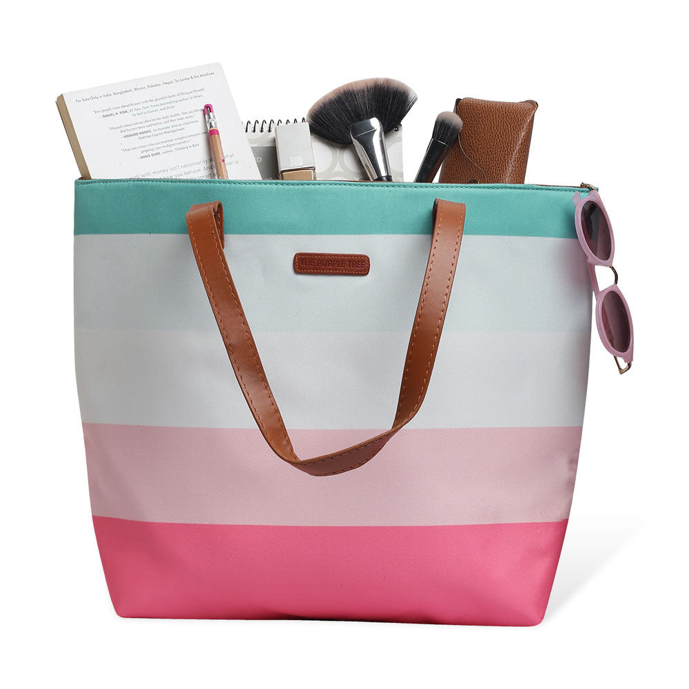 Chic tote bag featuring pink, blue, and white stripes, ideal for adding a pop of color to your outfit.