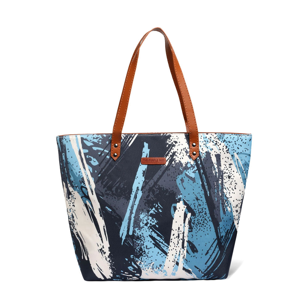 Trendy tote bag featuring a paint brush print in blue and white, great for art lovers.