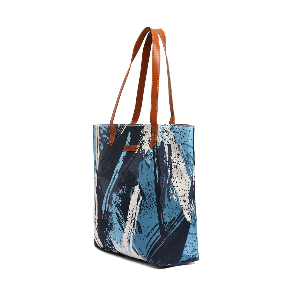 Fashionable blue and white tote bag adorned with a paint brush pattern, a must-have for artists.