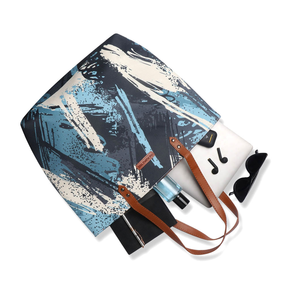 Stylish tote bag in blue and white with a fun paint brush design, ideal for art enthusiasts.