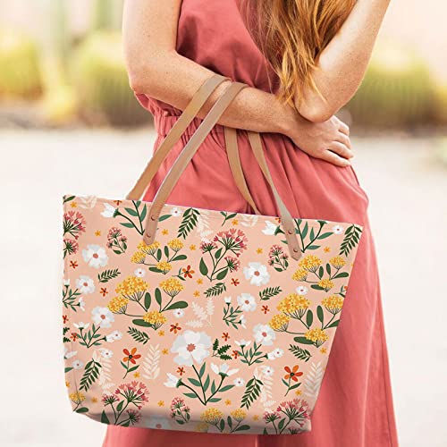 Stylish floral print tote bag with brown leather handles.