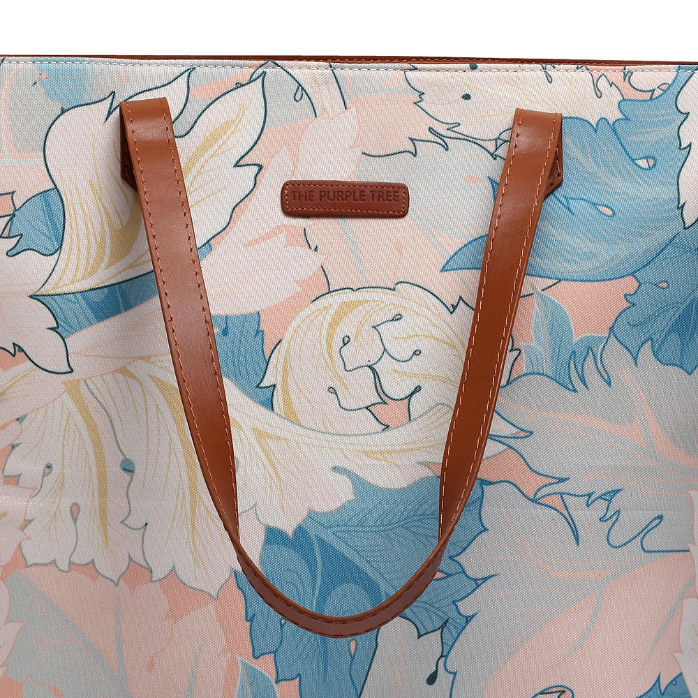 Stylish floral print tote bag, perfect for carrying all your essentials on a sunny day out.