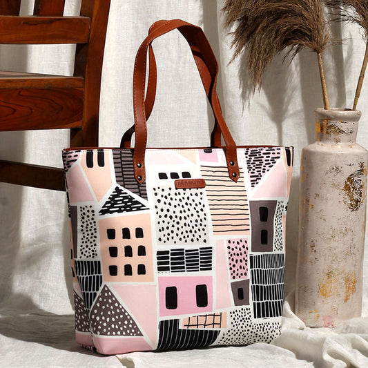 Pink and black tote bag with house pattern, perfect for carrying essentials in style.