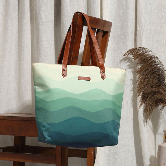 A stylish tote bag featuring a wave design, perfect for carrying essentials to the beach or on a casual day out.