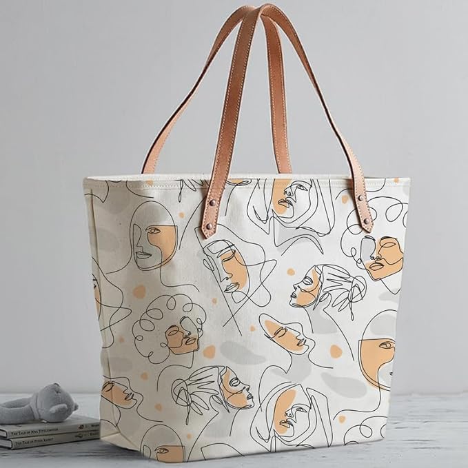 Fashionable white tote bag with a stylish print of women's faces.