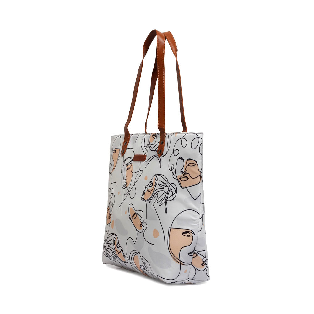 Stylish white tote bag featuring a unique pattern of women's faces, a chic accessory.