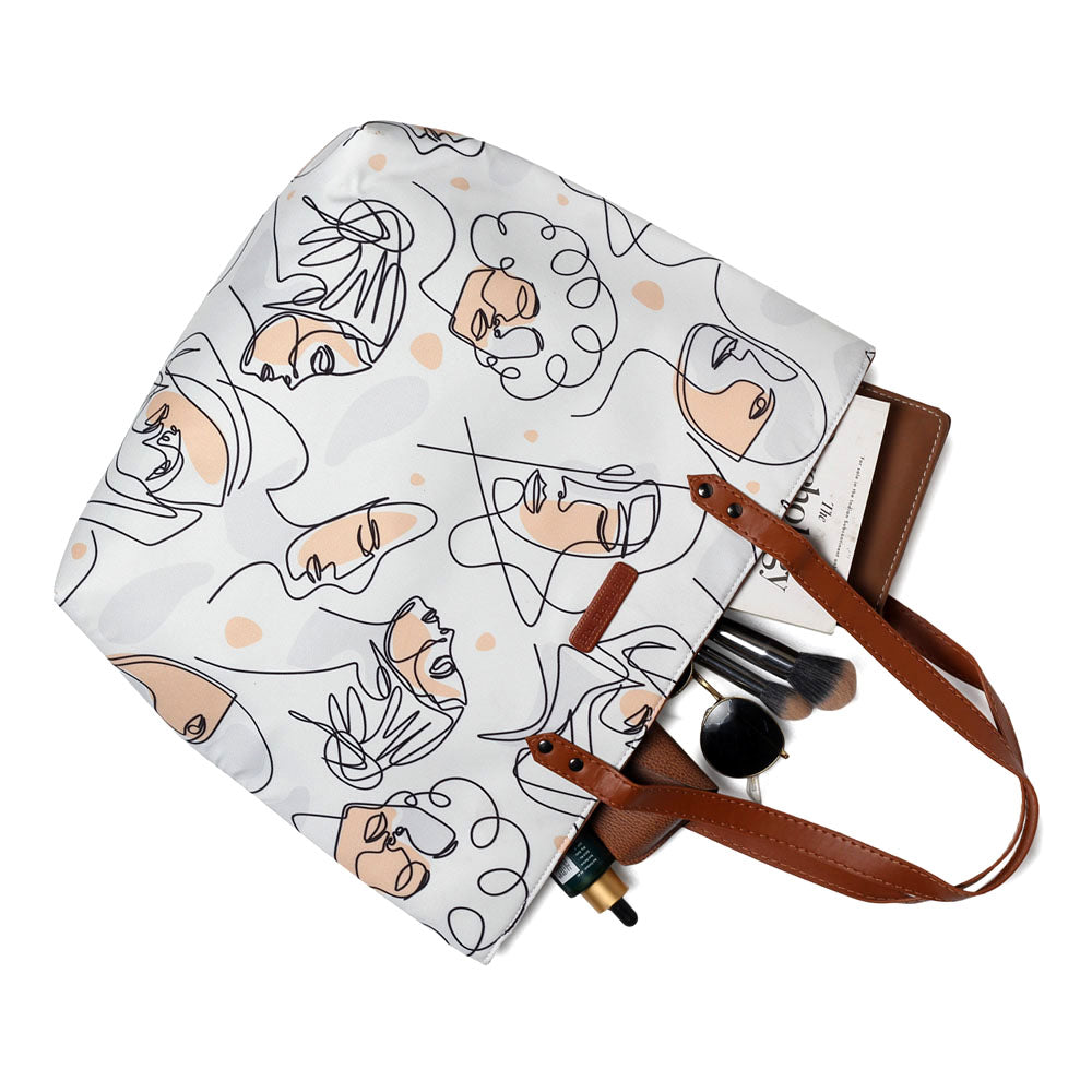 Trendy white tote bag adorned with a fashionable pattern of women's faces.