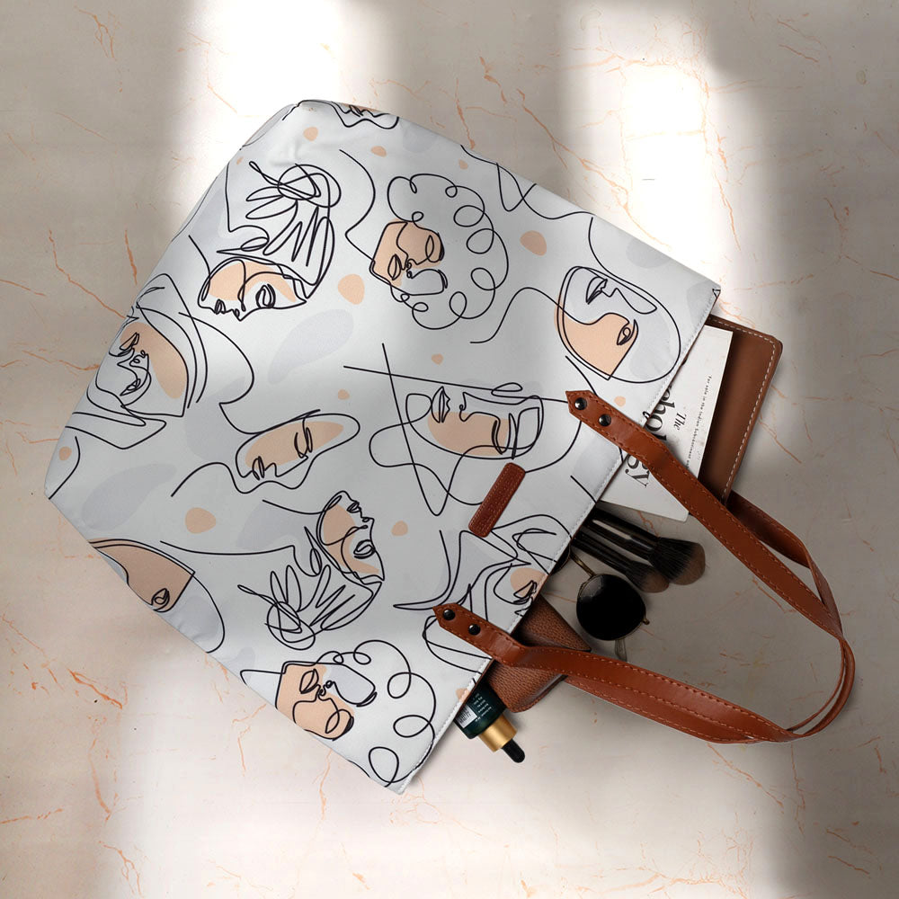 Stylish white tote bag with an eye-catching pattern of women's faces.