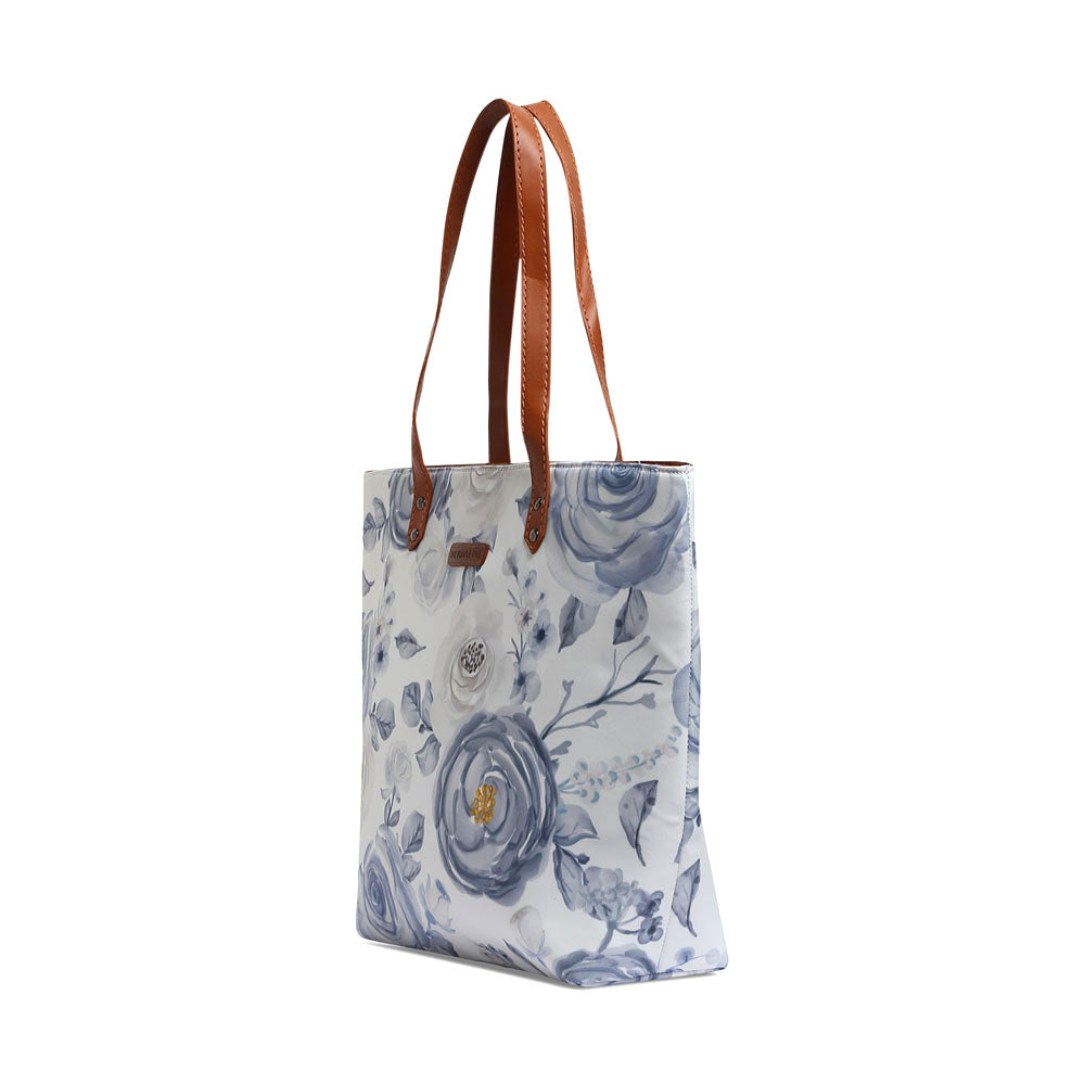 White and blue floral print tote bag, perfect for carrying essentials in style.