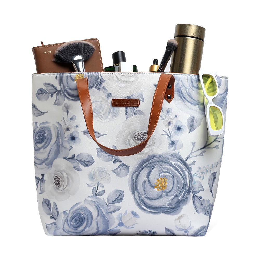 Stylish white and blue floral print tote bag, ideal for everyday use.