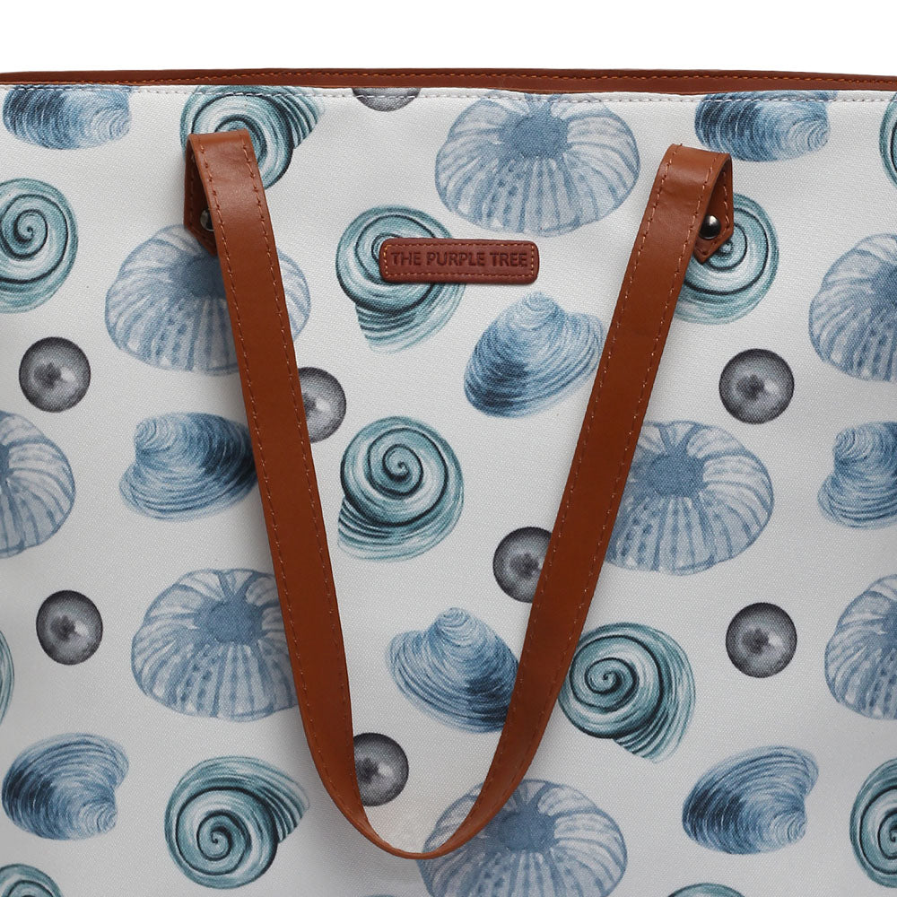 Elegant white and blue tote bag decorated with delicate seashells.