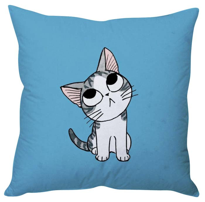 Cute cat resting on blue pillow, with a relaxed expression.