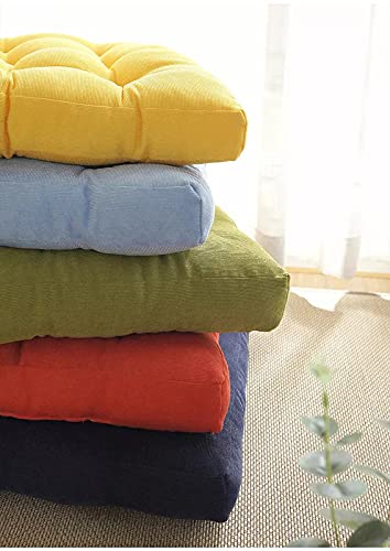 Colorful pillows arranged on a carpet.