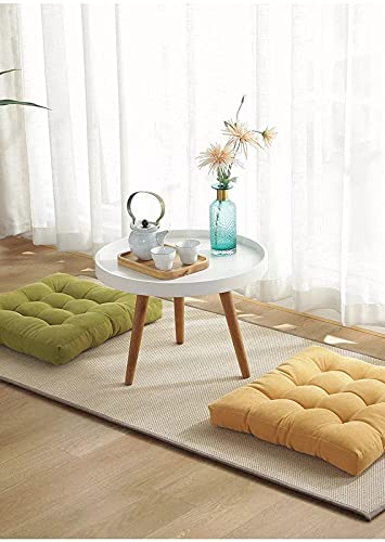 White table with yellow and green cushions.