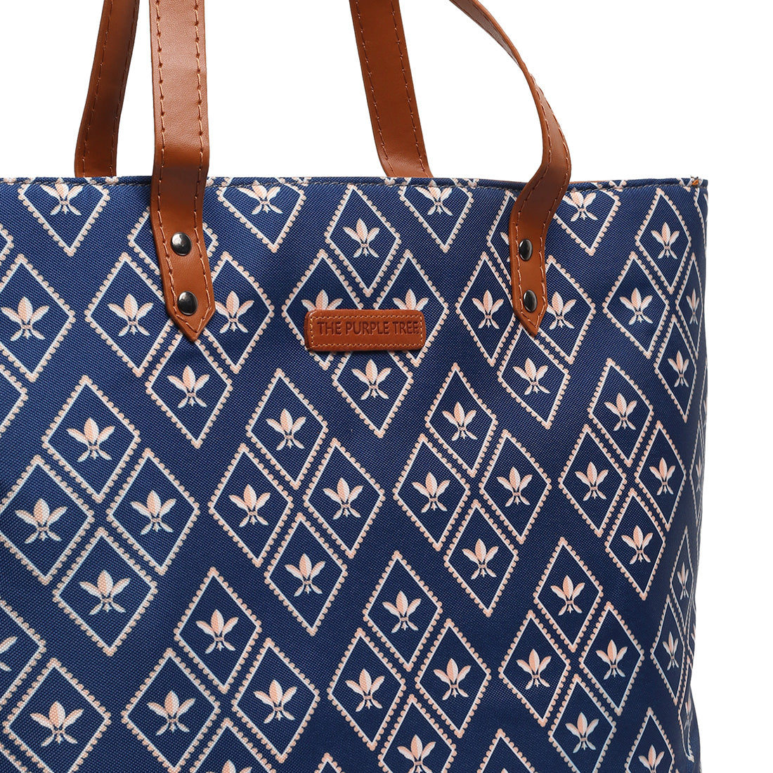 A chic tote bag in blue and brown colors near a wooden chair