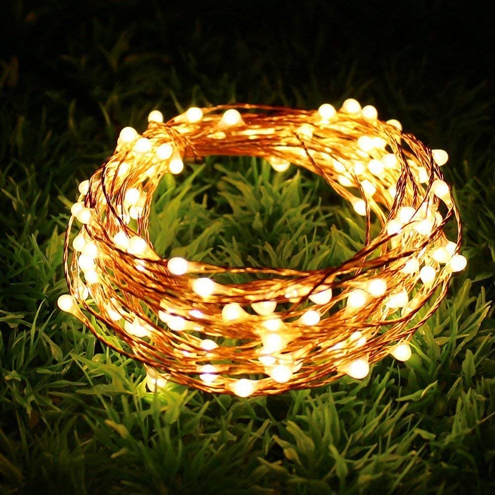 A string of lights illuminating the grass, creating a warm and inviting ambiance.