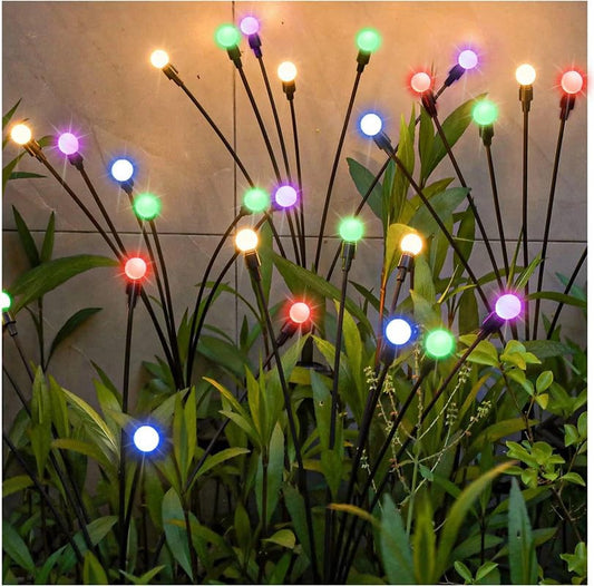  Solar powered garden lights with colorful lights illuminating a backyard at night.
